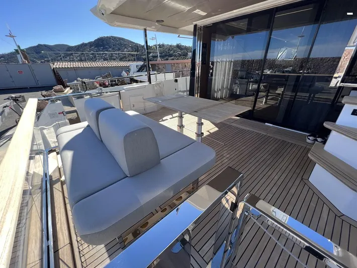 Yacht Photos Pics Luxurious 2023 Prestige X60 yacht deck with modern seating and scenic views.