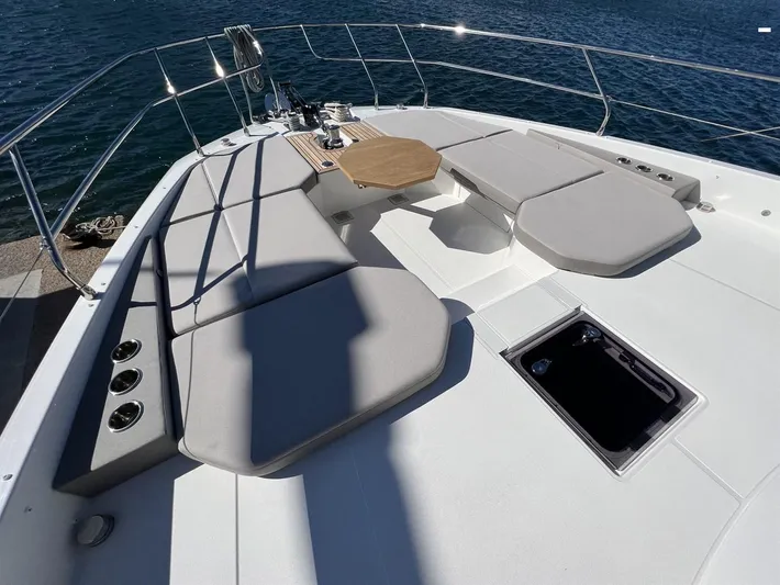  Yacht Photos Pics 2023 Prestige X60 yacht deck with cushioned seating and ocean view.