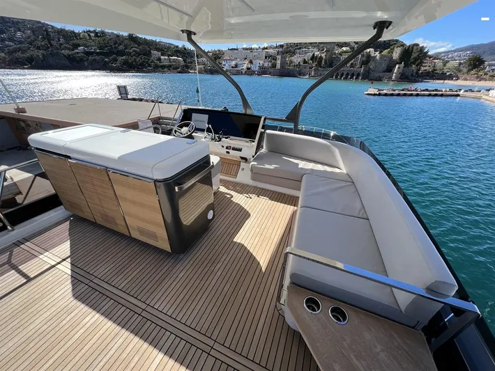  Yacht Photos Pics Luxurious 2023 Prestige X60 yacht deck with seating, overlooking serene blue waters.