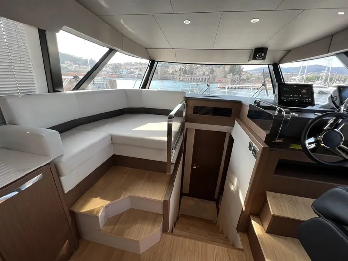  Yacht Photos Pics Luxurious interior of 2023 Prestige X60 yacht with modern helm and seating area.