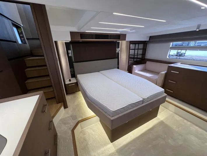  Yacht Photos Pics Luxurious interior of 2023 Prestige X60 yacht featuring a spacious bedroom with modern design.