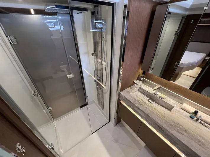  Yacht Photos Pics Luxurious bathroom in 2023 Prestige X60 yacht with glass shower and modern vanity.