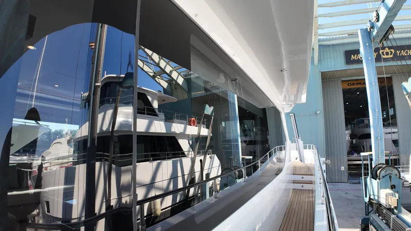  Yacht Photos Pics 2024 Gulf Craft Nomad 65 yacht docked at marina, reflecting modern design and luxury.