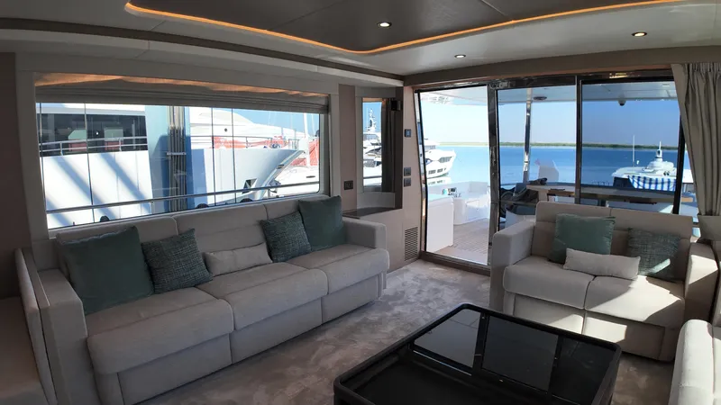 Yacht Photos Pics Luxurious interior of 2024 Gulf Craft Nomad 65 yacht with modern seating and ocean view.