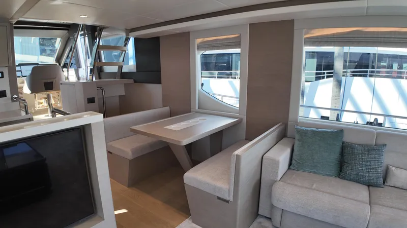  Yacht Photos Pics Interior of 2024 Gulf Craft Nomad 65 yacht, featuring modern seating and dining area.