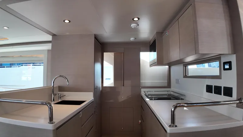  Yacht Photos Pics Modern kitchen interior of 2024 Gulf Craft Nomad 65 yacht, featuring sleek cabinetry and appliances.