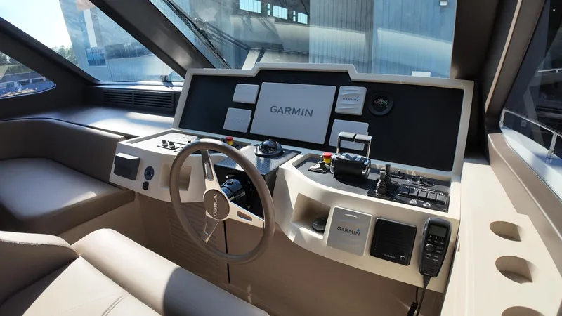  Yacht Photos Pics 2024 Gulf Craft Nomad 65 helm with Garmin navigation system and modern controls.