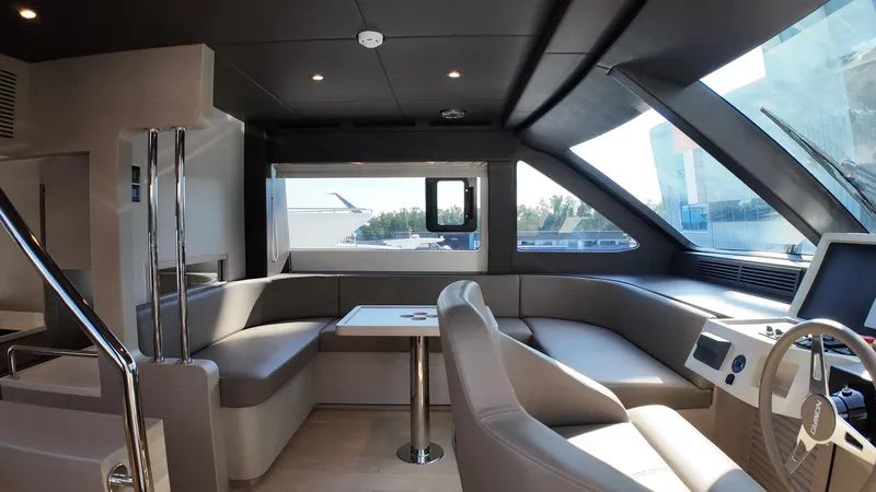  Yacht Photos Pics Luxurious interior of 2024 Gulf Craft Nomad 65 yacht with modern seating and helm.