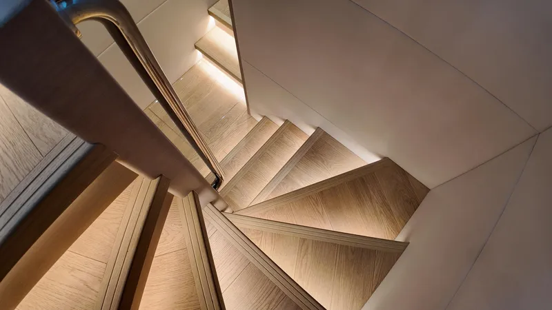  Yacht Photos Pics Staircase with wooden steps and ambient lighting on a 2024 Gulf Craft Nomad 65 yacht.