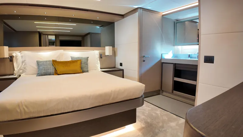  Yacht Photos Pics Luxurious bedroom interior of 2024 Gulf Craft Nomad 65 yacht, featuring modern design and elegant furnishings.