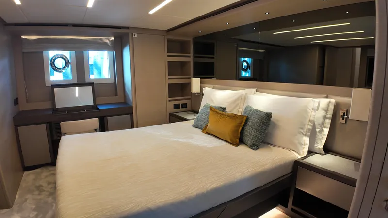  Yacht Photos Pics Luxurious bedroom interior of 2024 Gulf Craft Nomad 65 yacht, featuring modern design and cozy ambiance.