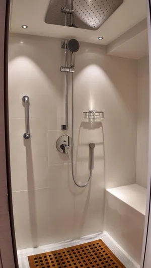  Yacht Photos Pics Luxurious shower in 2024 Gulf Craft Nomad 65 yacht with modern fixtures and seating.