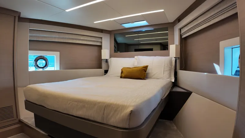  Yacht Photos Pics Luxurious bedroom interior of 2024 Gulf Craft Nomad 65 yacht with modern design and cozy bedding.