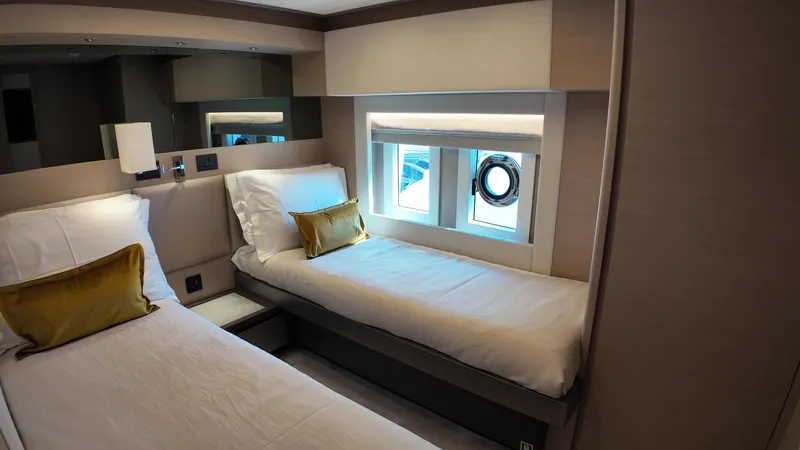  Yacht Photos Pics 2024 Gulf Craft Nomad 65 cabin with twin beds and modern interior design.