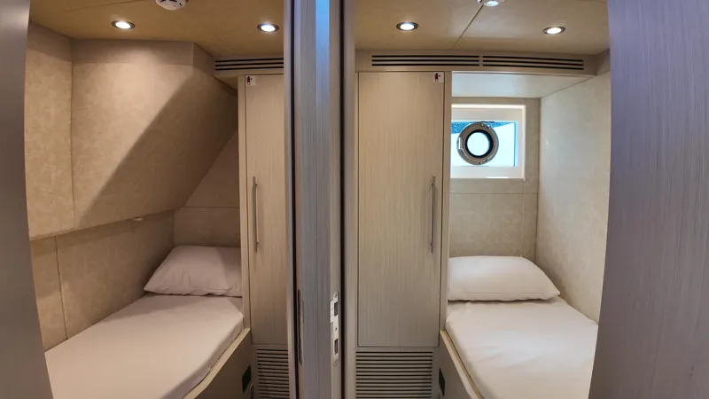  Yacht Photos Pics 2024 Gulf Craft Nomad 65 yacht interior with twin cozy cabins and modern lighting.