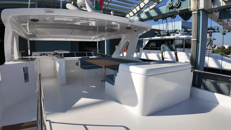  Yacht Photos Pics 2024 Gulf Craft Nomad 65 yacht deck with seating and table under canopy.