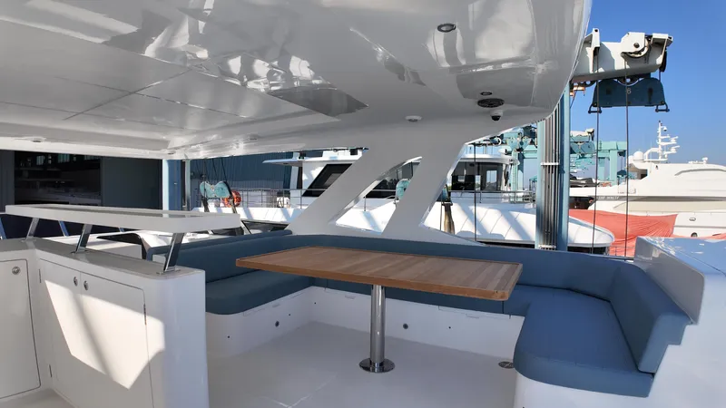  Yacht Photos Pics Luxurious 2024 Gulf Craft Nomad 65 yacht interior with seating and table.