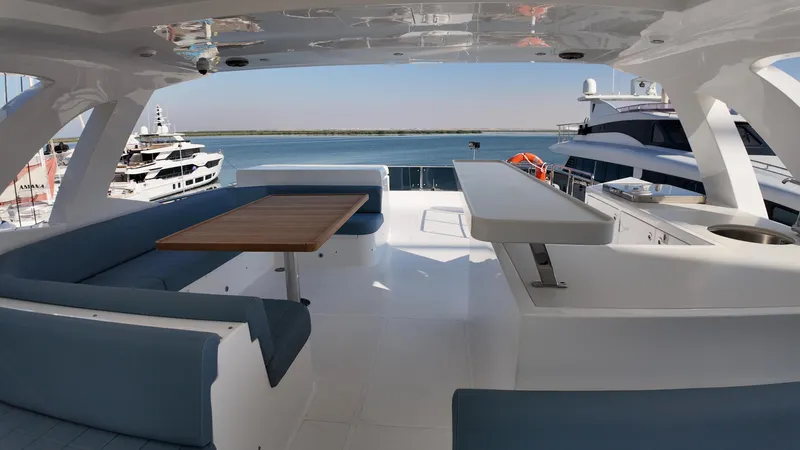  Yacht Photos Pics 2024 Gulf Craft Nomad 65 yacht deck with seating and ocean view.