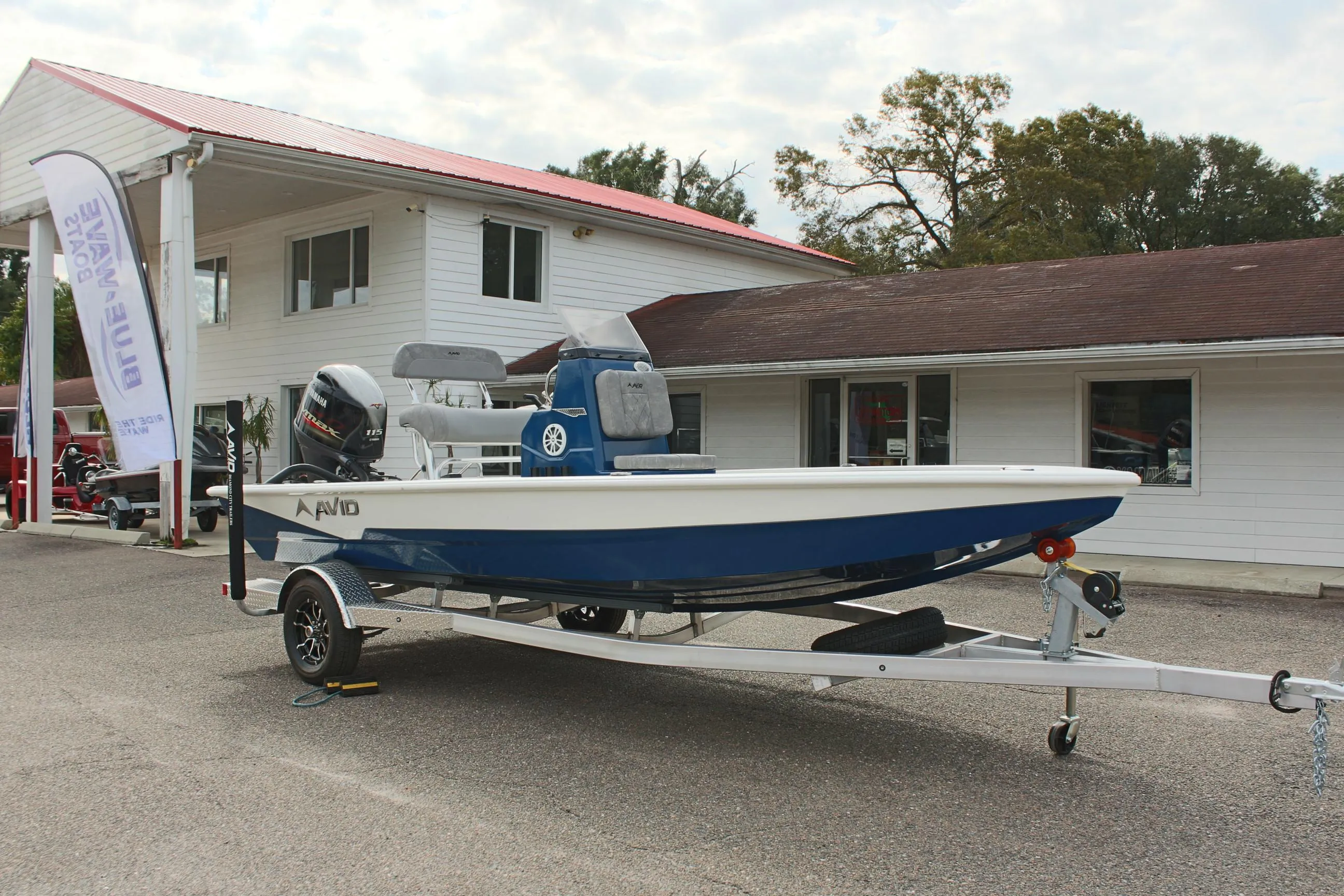 2025 Avid 19 FSX boat on trailer outside dealership.