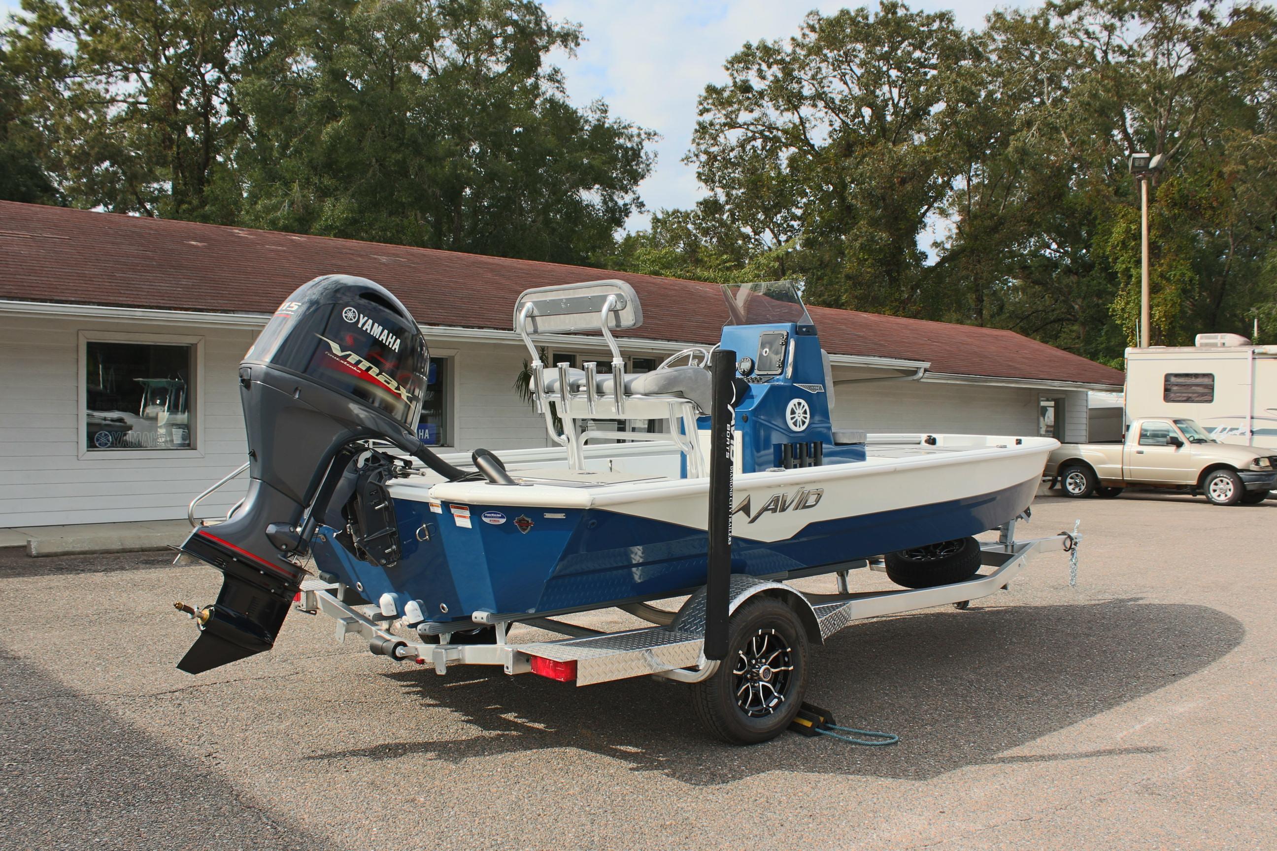 2025 Avid 19 FSX boat with Yamaha motor on trailer, parked outdoors.