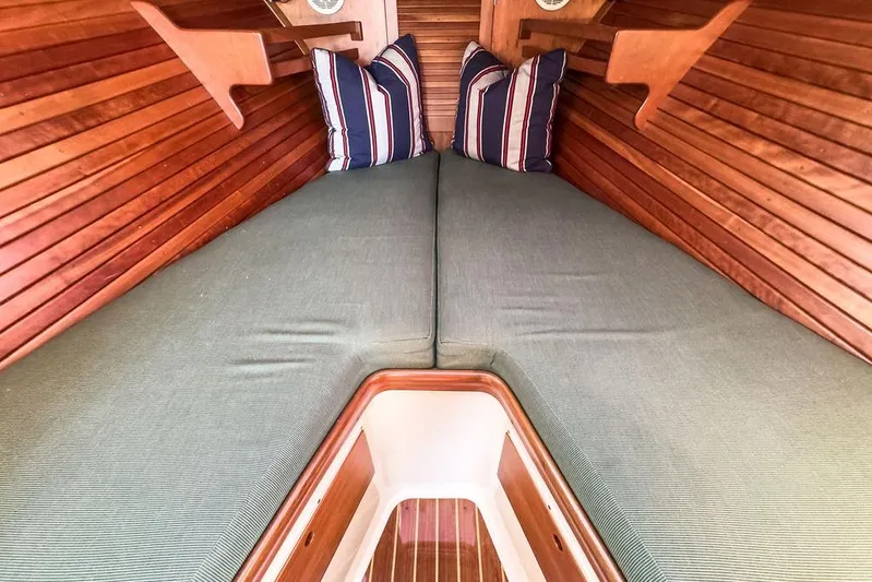Hobnob Yacht Photos Pics Interior of 2001 Hinckley Yachts Picnic Boat Classic 36 with cozy bedding and striped pillows.