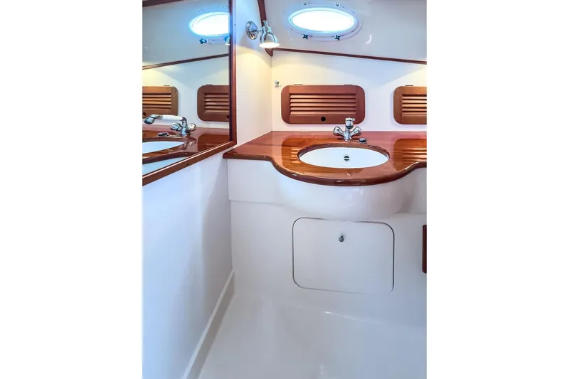 Hobnob Yacht Photos Pics Elegant bathroom in 2001 Hinckley Yachts Picnic Boat Classic 36 with wooden accents.