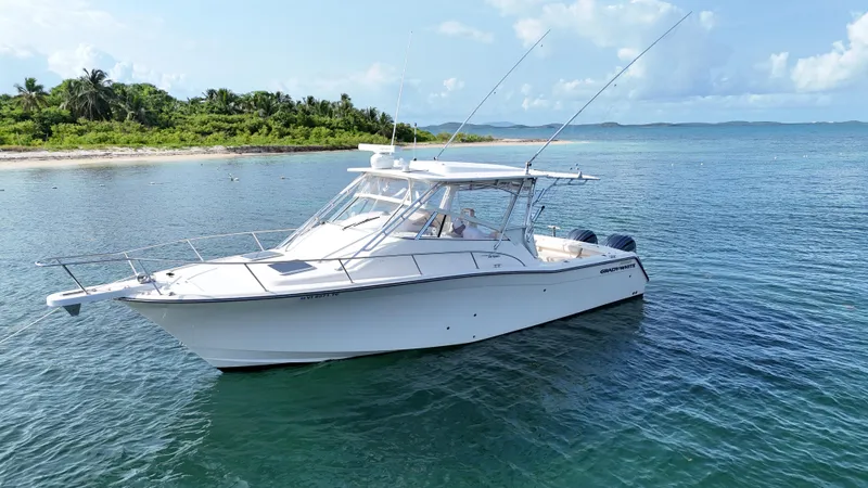  Yacht Photos Pics 2006 Grady-White Express 330 boat anchored near tropical shoreline.