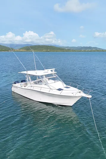  Yacht Photos Pics 2006 Grady-White Express 330 boat anchored on calm blue water.