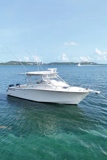  Yacht Photos Pics 2006 Grady-White Express 330 boat on calm blue water, clear sky background.