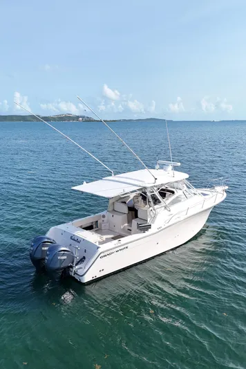  Yacht Photos Pics 2006 Grady-White Express 330 boat on calm blue water, featuring twin outboard engines.