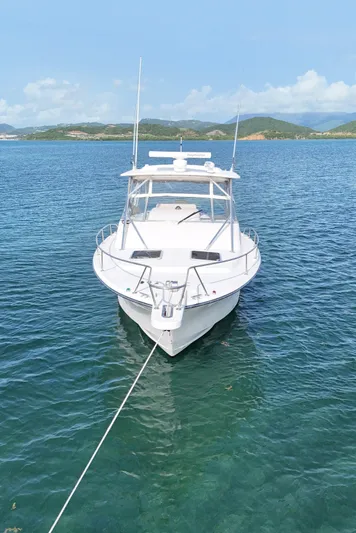  Yacht Photos Pics 2006 Grady-White Express 330 boat anchored in clear blue water.