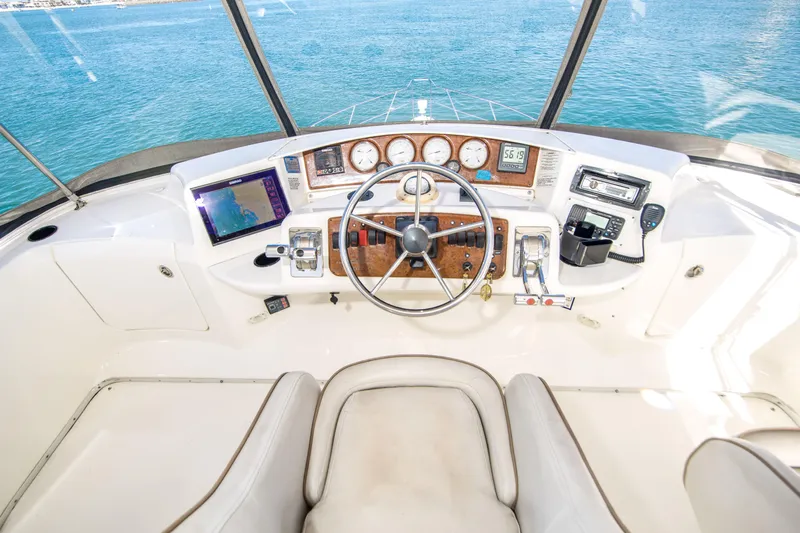 Journeys Edge Yacht Photos Pics 2007 Silverton 36 Convertible yacht helm with ocean view, featuring modern navigation instruments.