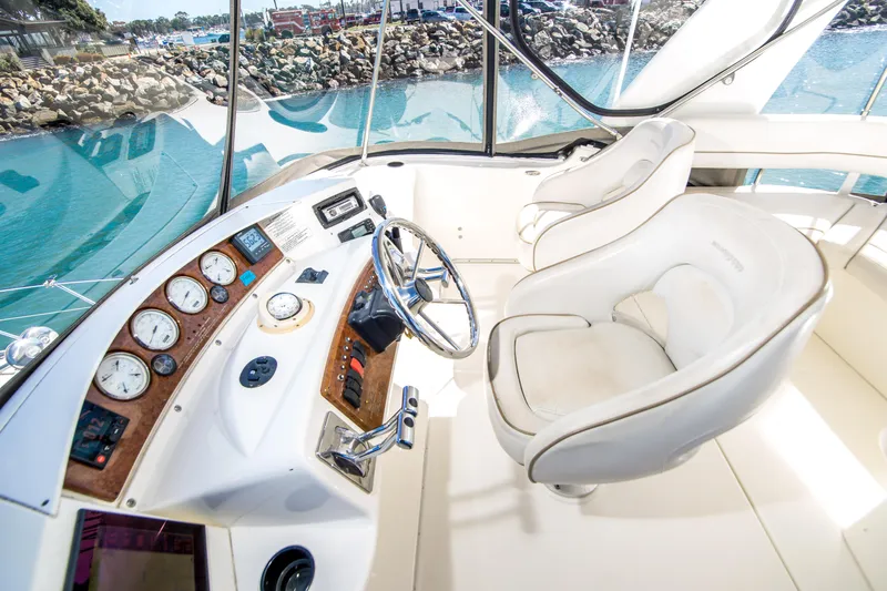 Journeys Edge Yacht Photos Pics 2007 Silverton 36 Convertible yacht helm with gauges, steering wheel, and plush captain's chair.