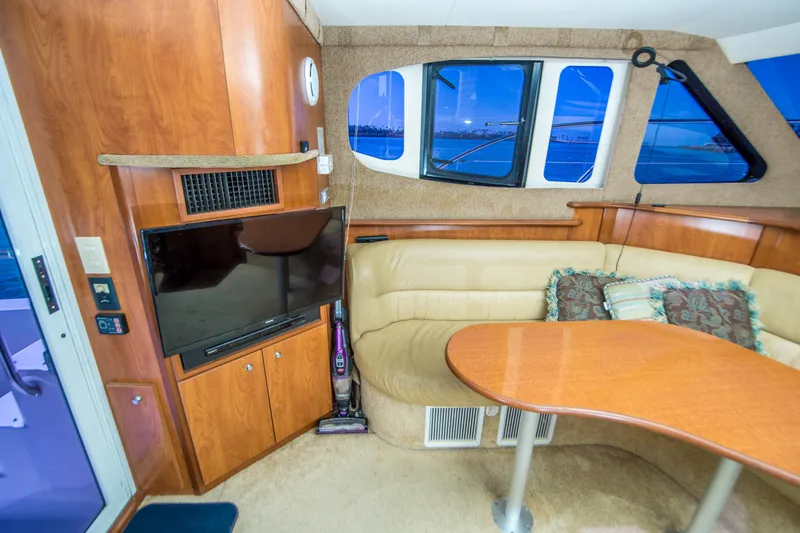 Journeys Edge Yacht Photos Pics Interior of 2007 Silverton 36 Convertible yacht with TV, seating, and table.