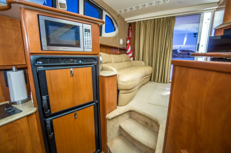 Journeys Edge Yacht Photos Pics Interior of 2007 Silverton 36 Convertible yacht with kitchen and seating area.