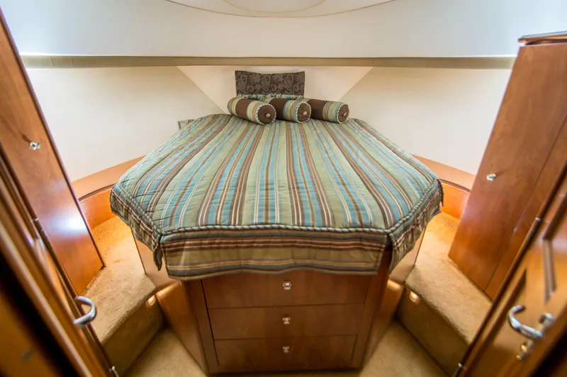 Journeys Edge Yacht Photos Pics Luxurious cabin interior of 2007 Silverton 36 Convertible yacht with striped bedding.