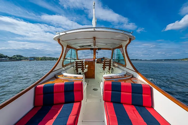 Comin' In Hot Yacht Photos Pics 2016 Hinckley Talaria 34 boat interior with striped seating, cruising on a sunny day.