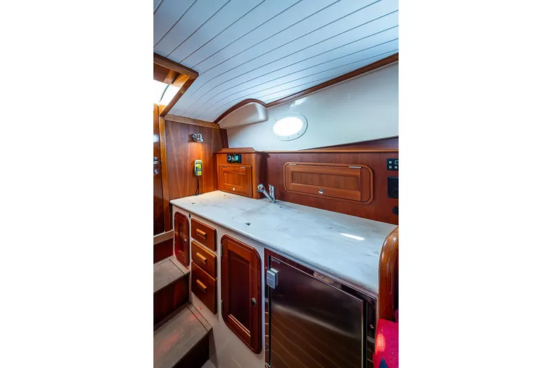 Comin' In Hot Yacht Photos Pics 2016 Hinckley Talaria 34 yacht interior with wooden cabinetry and sleek countertop.