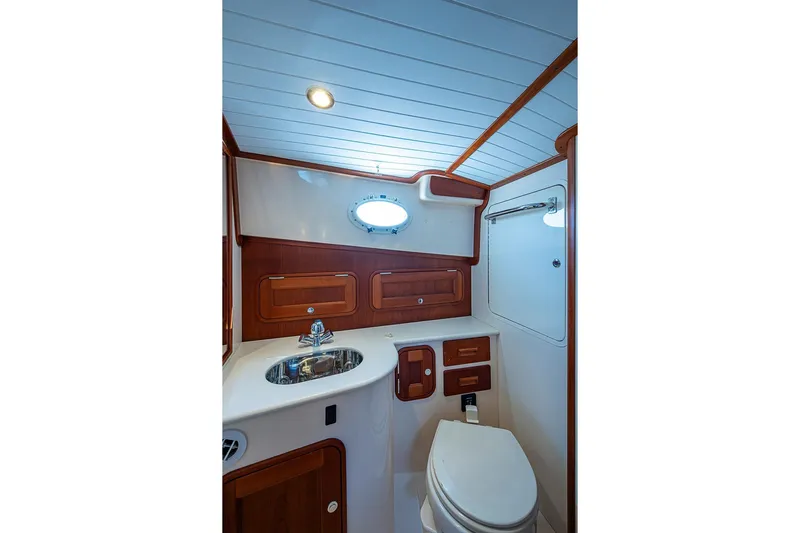 Comin' In Hot Yacht Photos Pics 2016 Hinckley Talaria 34 yacht bathroom with wood accents and modern fixtures.