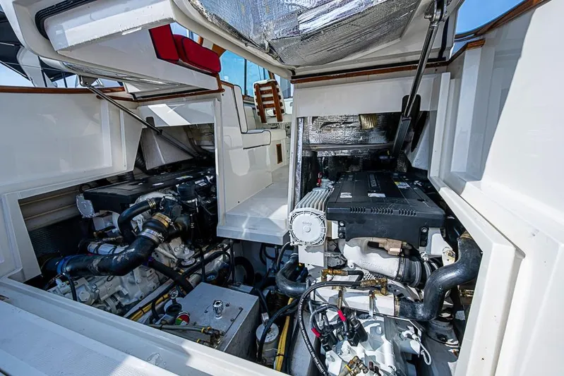 Comin' In Hot Yacht Photos Pics Engine compartment of a 2016 Hinckley Talaria 34 boat, showcasing dual engines.