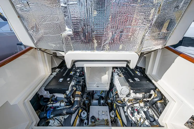 Comin' In Hot Yacht Photos Pics Engine compartment of a 2016 Hinckley Talaria 34 boat, showcasing dual engines.