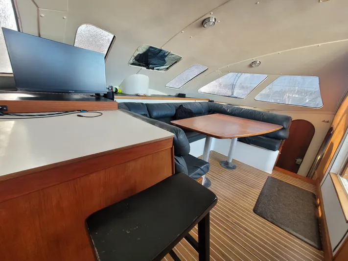 Ki Zen Yacht Photos Pics Interior of 1995 Lagoon TPI 42 yacht with seating area and table.