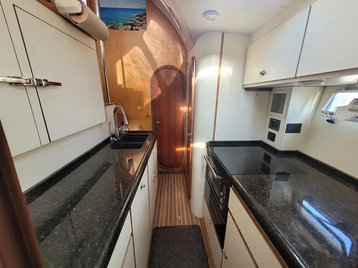 Ki Zen Yacht Photos Pics Interior of 1995 Lagoon TPI 42 yacht kitchen with sleek countertops and modern appliances.