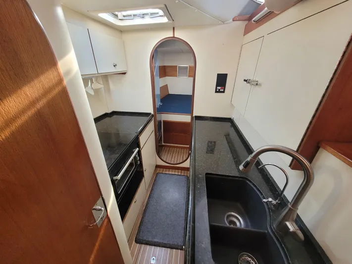 Ki Zen Yacht Photos Pics Interior of 1995 Lagoon TPI 42 yacht, featuring a compact kitchen and cozy cabin.