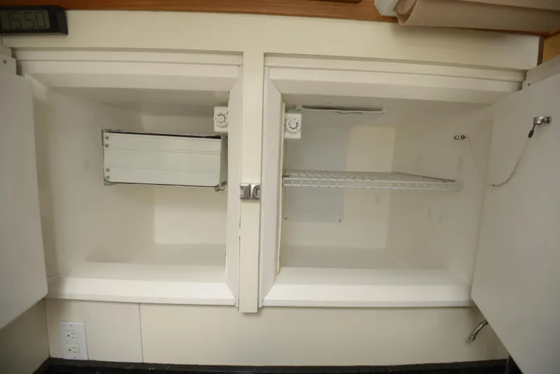 Ki Zen Yacht Photos Pics Empty storage compartment in 1995 Lagoon TPI 42 boat interior.