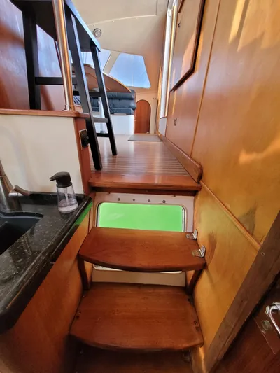 Ki Zen Yacht Photos Pics Interior of 1995 Lagoon TPI 42 yacht with wooden stairs and modern design.