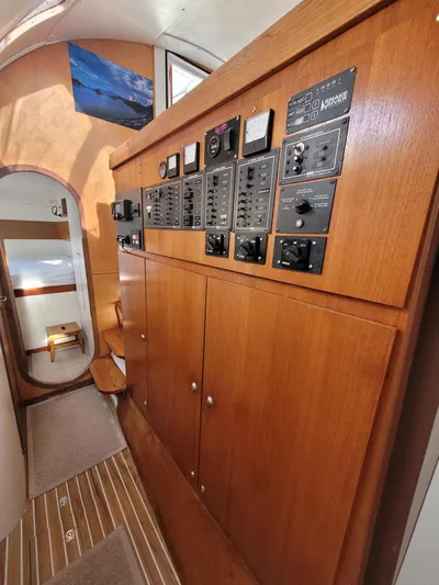 Ki Zen Yacht Photos Pics Interior of 1995 Lagoon TPI 42 yacht with control panels and wooden cabinetry.