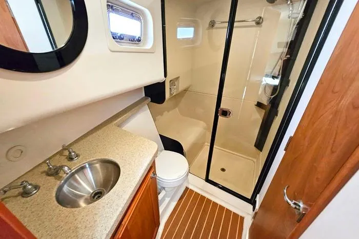  Yacht Photos Pics Bathroom of 2007 Mainship 34 Trawler with sink, toilet, and shower.