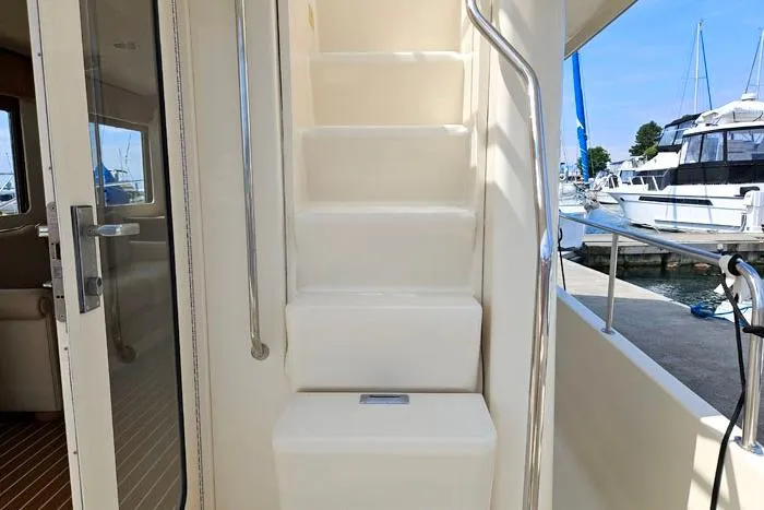  Yacht Photos Pics Staircase on 2007 Mainship 34 Trawler, leading to upper deck, docked at marina.