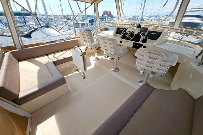  Yacht Photos Pics 2007 Mainship 34 Trawler interior with helm, seating, and marina view.